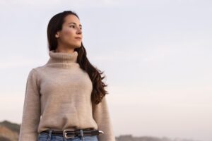 front-view-woman-posing-stoic-by-beach-with-copy-space